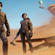 Two black-suited warriors stand on sand dunes, a large worm reaching for a floating bus in the distant background.